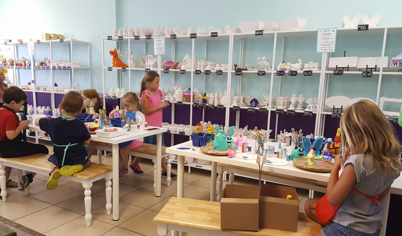 Children painting in a ceramic studio